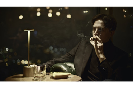 Young man elegantly smokes cigar, a Person Photo by Media Whale Stock