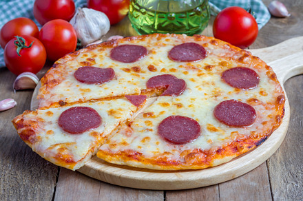 Homemade pepperoni pizza on a wooden board, ready to eat, a Food & Drink Photo by iuliia_n