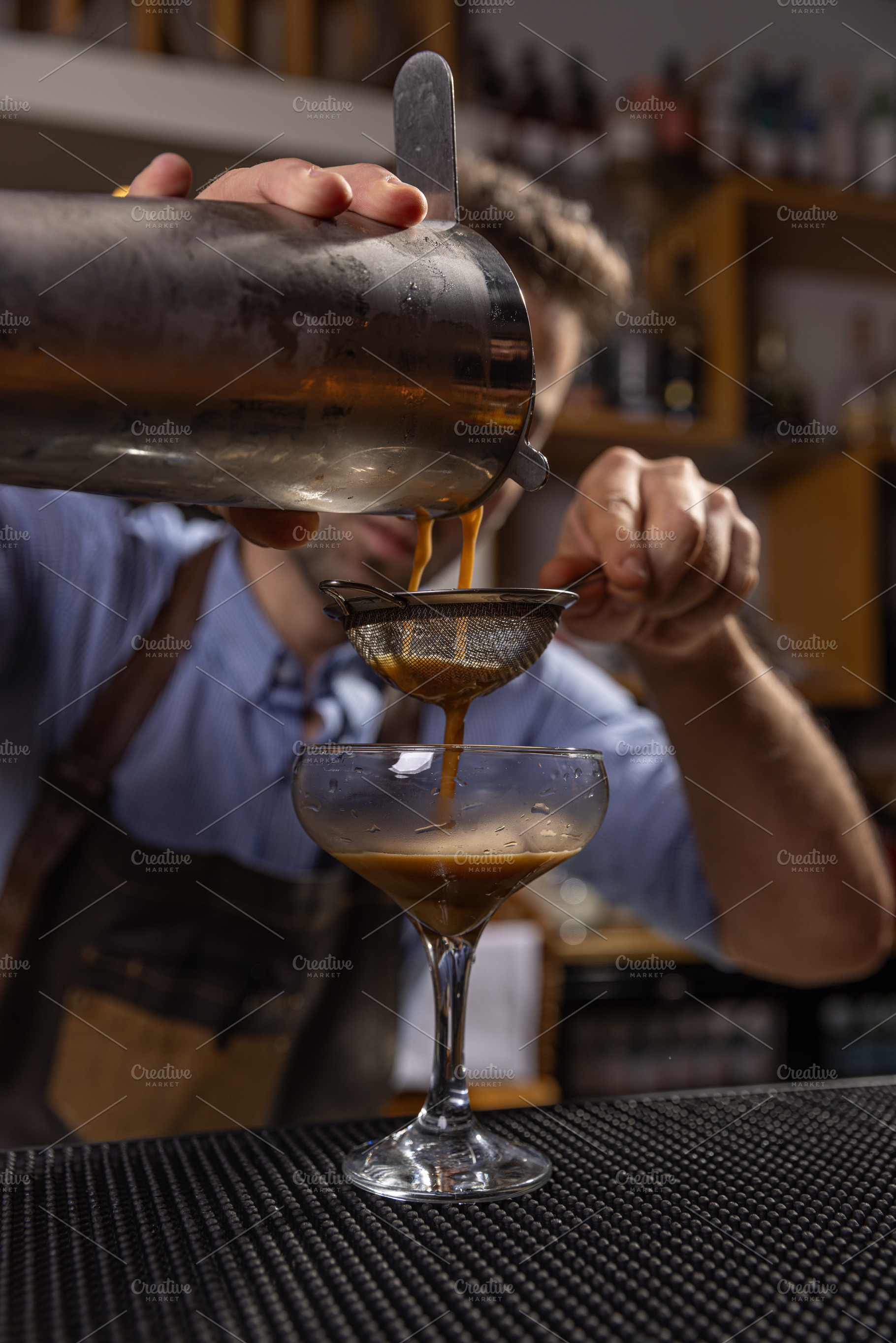 Bartender pouring espresso martini cocktail, a Photo by Grafvision photography