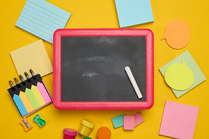 Chalkboard in a pink wooden frame with a piece of chalk, surroun, a School & Education Photo by ndanko