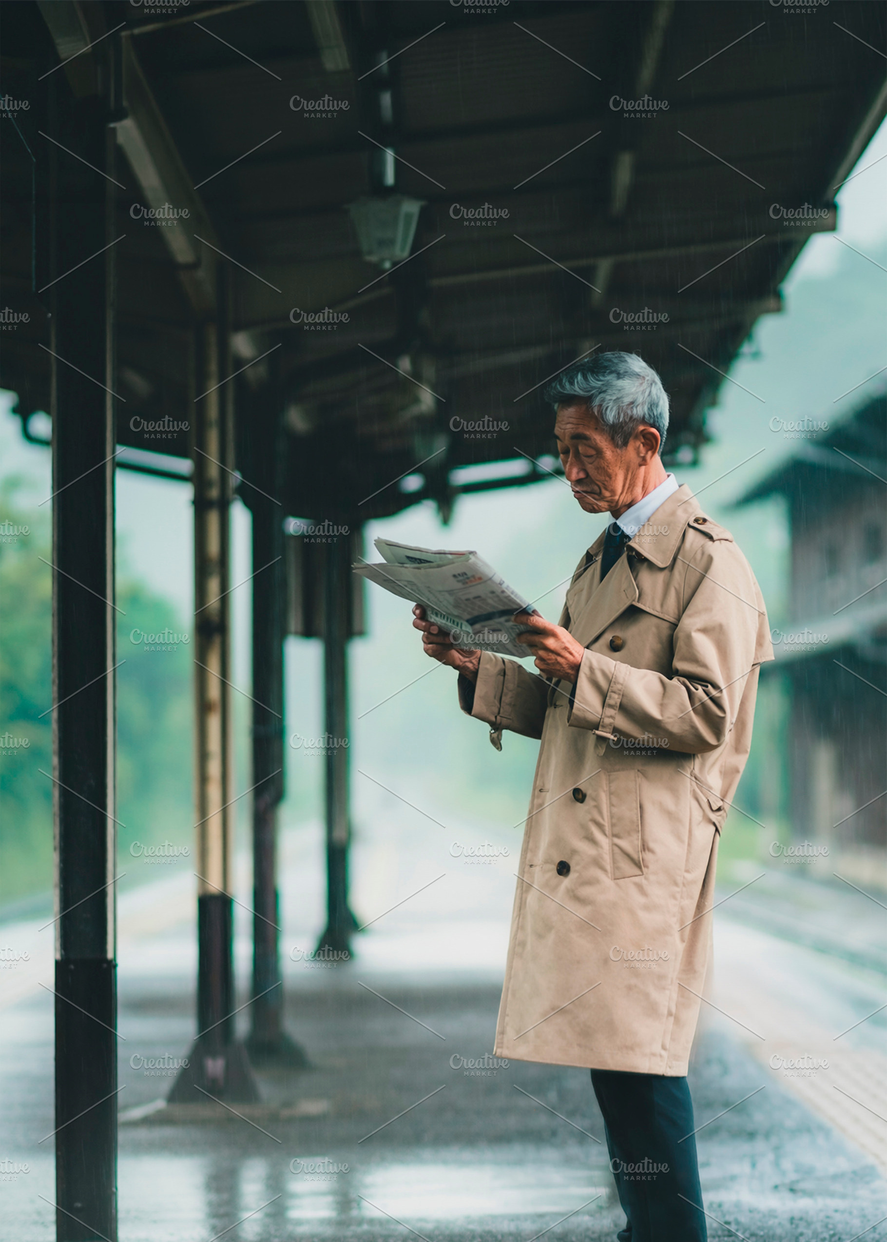 Asian senior traveler reading train departure information on a s, a Person Photo by DanFLCreativo