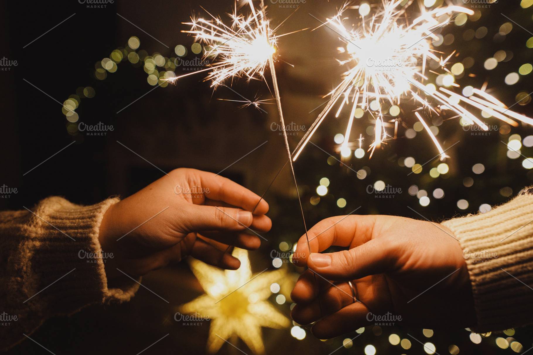 Happy New Year! Burning sparklers in hands on background of chri, a Holiday Photo by Sonjachni