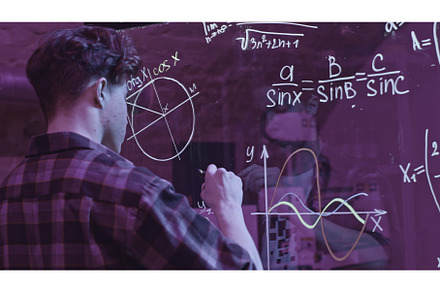 Young man solves mathematical, a School & Education Photo by Media Whale Stock