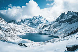 A snowy mountain range with a lake, a Photo by Pavel_design