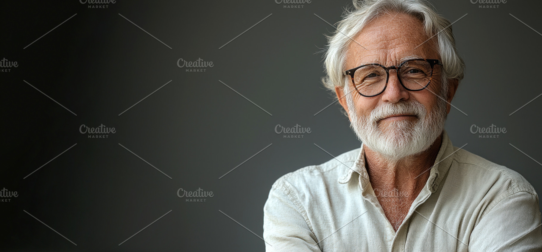 Smiling senior man with white hair and beard wearing glasses and, a Person Photo by José Manuel Gelpi