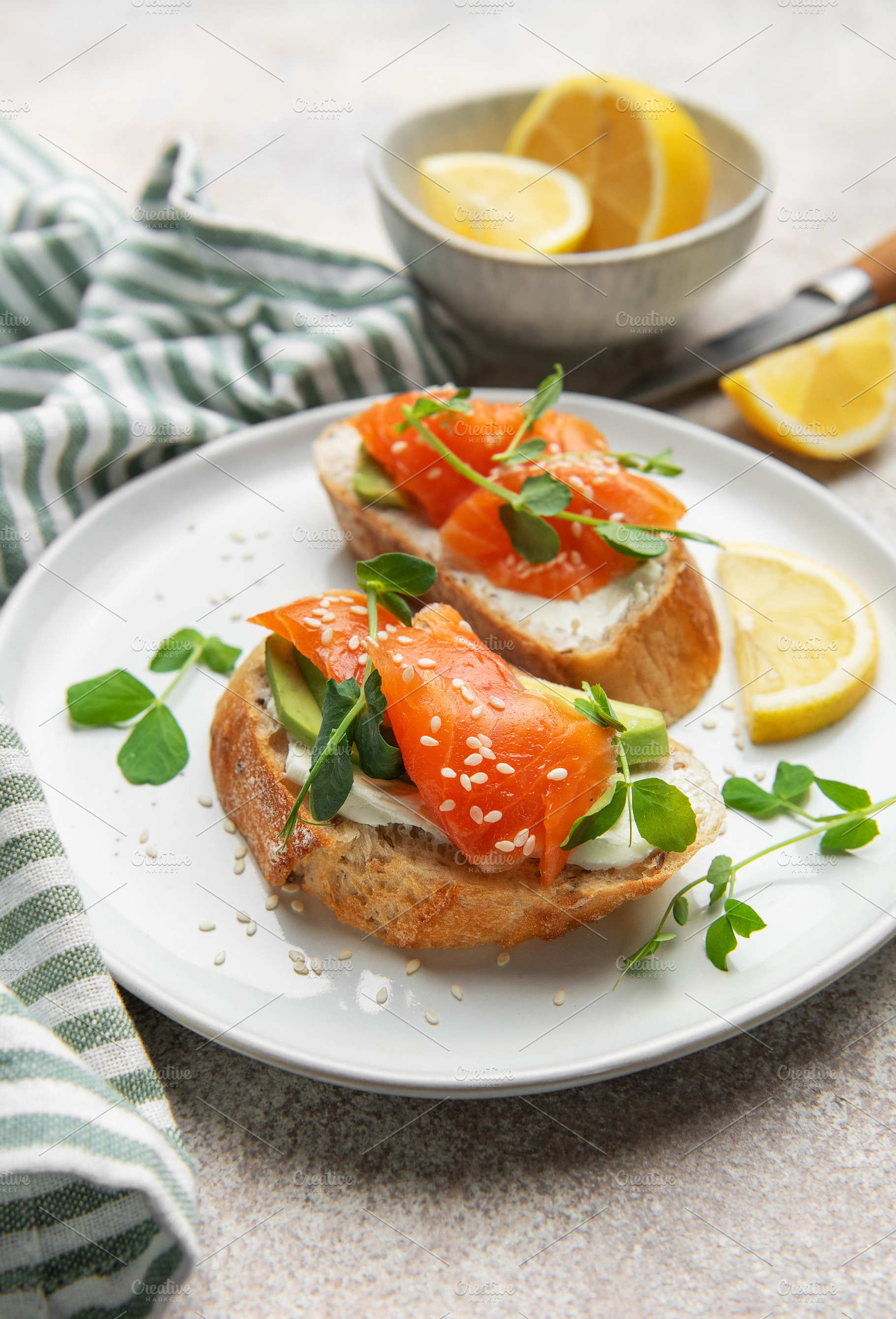 Salmon avocado toasts with microgreens and lemon, a Food & Drink Photo by Olena Rudo