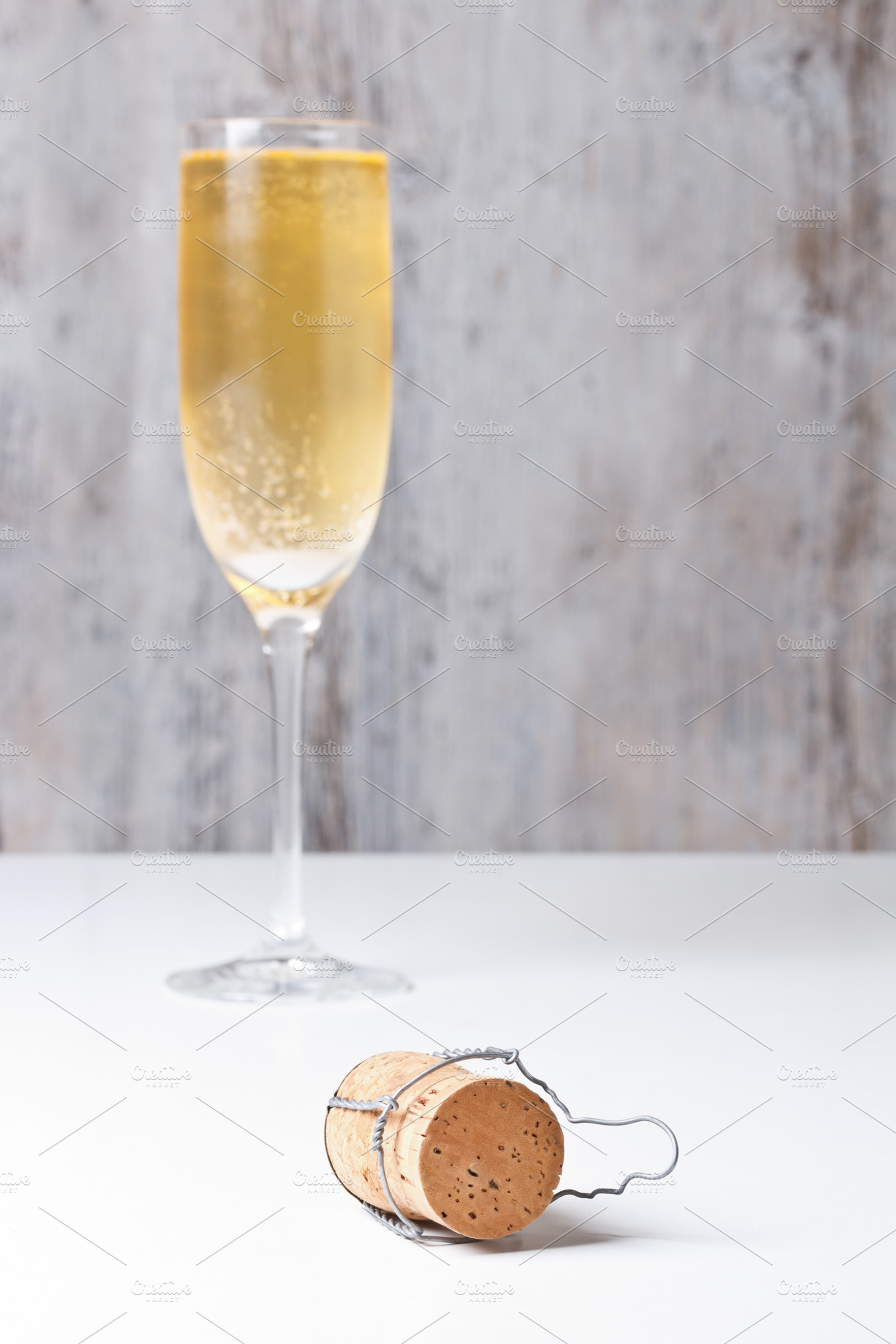 Champagne glass and cork featuring alcohol, background, and beverage