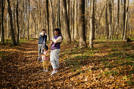 Mother with kids in family leisure at autumn activity in forest., a Person Photo by AS photostudio