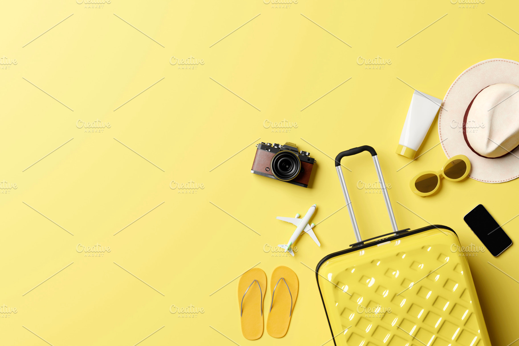 Summer travel accessories flat lay on yellow background, a Holiday Photo by RF Images