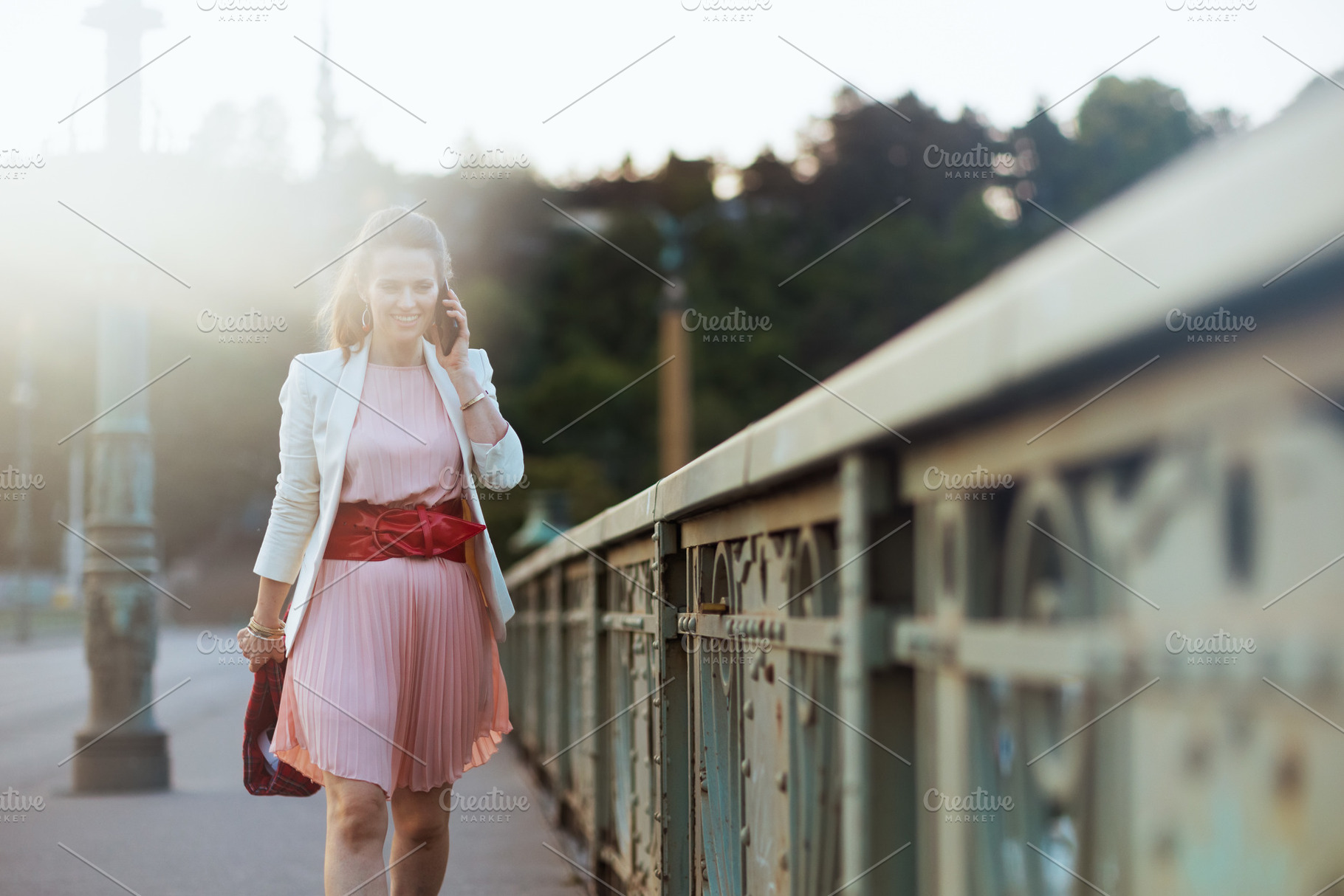 happy stylish 40 years old woman in city talking on phone, a Person Photo by Alliance Images
