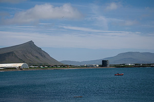 Serene view of Akranes coast with mountain and calm water in Iceland, a Photo by AS photostudio