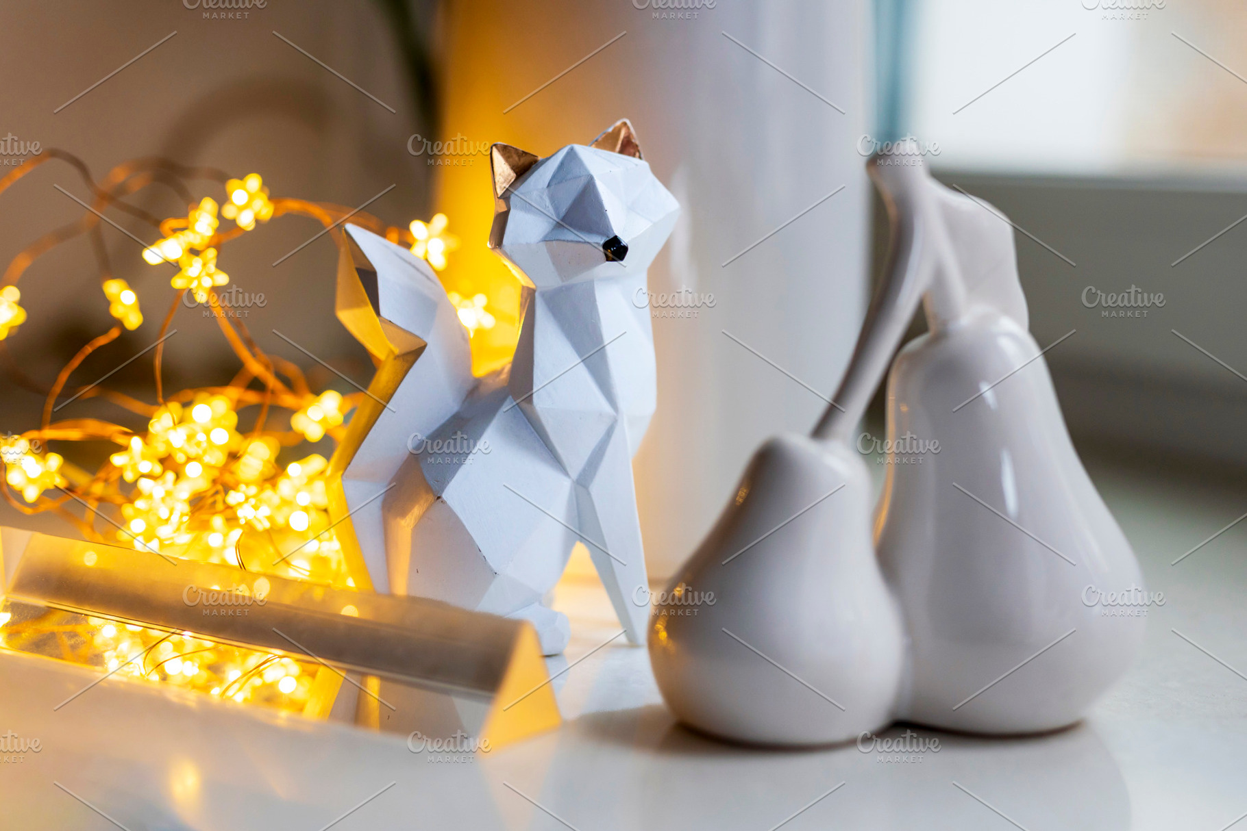 Geometric white fox figurine next to, a Holiday Photo by Imaginarium