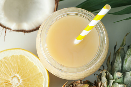 Pina colada cocktail and ingredients on white background, a Food & Drink Photo by AtlasStudio