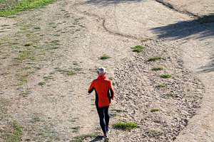Senior man running on dirt trail from aerial perspective, a Sports & Recreation Photo by RF Images