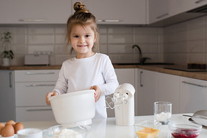 Child girl making cake