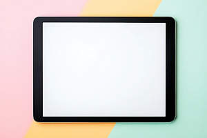 A tablet with a blank white screen is set against a vibrant geometric backdrop, a Technology Photo by AlyaAnd