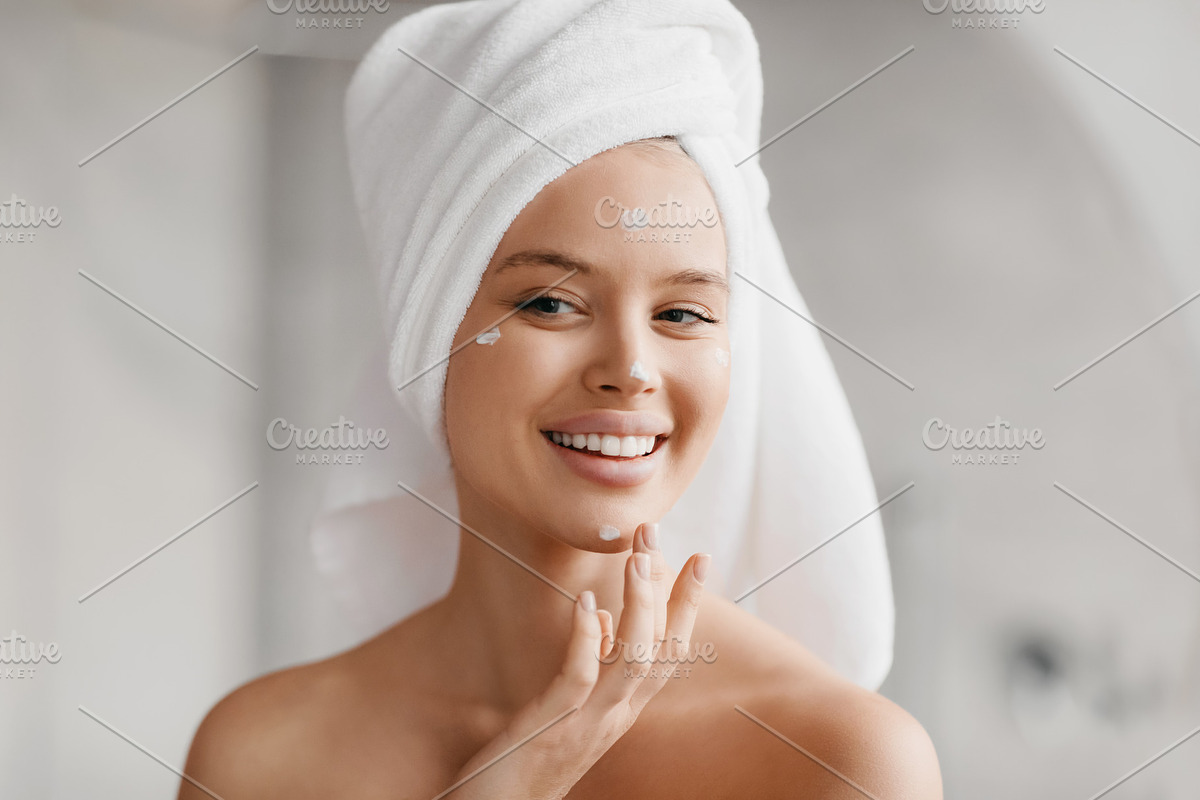 Healthy skin, care and moisturizing concept. Happy caucasian lady with towel on, a Photo by Prostock-Studio (Photo 1 of 2)