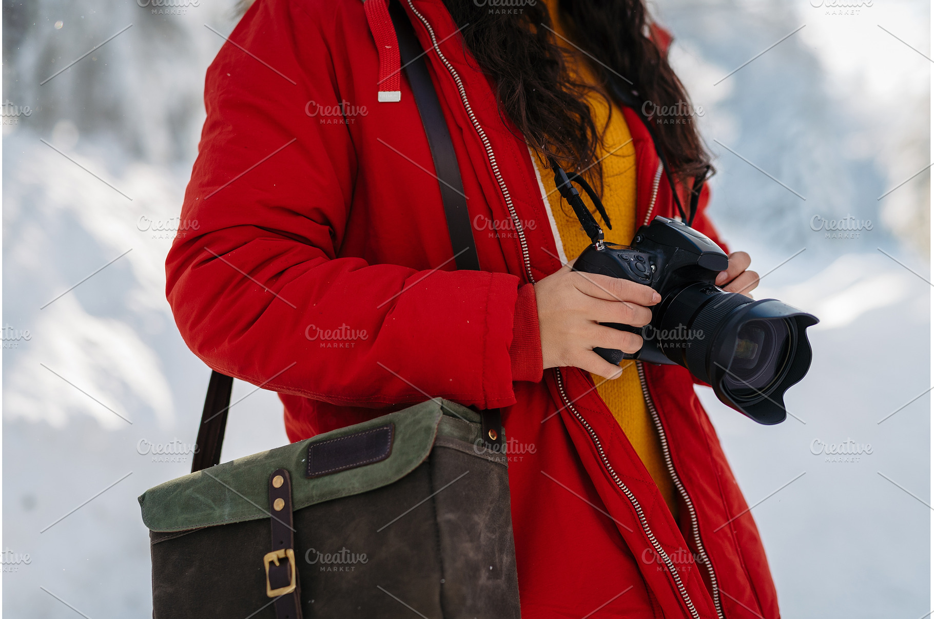 Woman holding camera during winter, a Beauty & Fashion Photo by HalfPoint