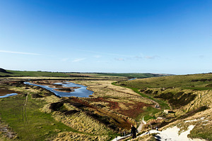 Hikers descend coastal path on Seven Sisters Cliffs in East Sussex UK, scenic l, a Nature Photo by AS photostudio