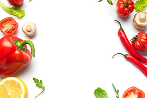 Fresh organic vegetables creating border on white background, a Food & Drink Photo by Olena Rudo