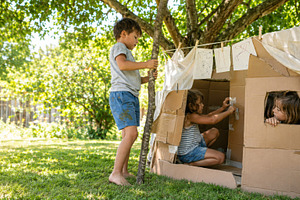 Children playing outdoors with cardb, a Photo by Dvoevnore photos