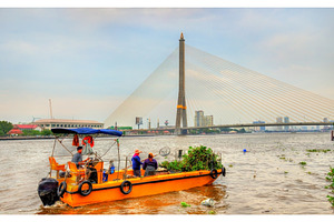Boat cleaning the Chao Phraya river in Bangkok, Thailand, a Transportation Photo by Leonid Andronov