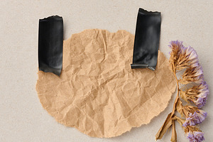 A crumpled sheet of kraft paper on a gray background, secured wi, an Abstract Photo by ndanko