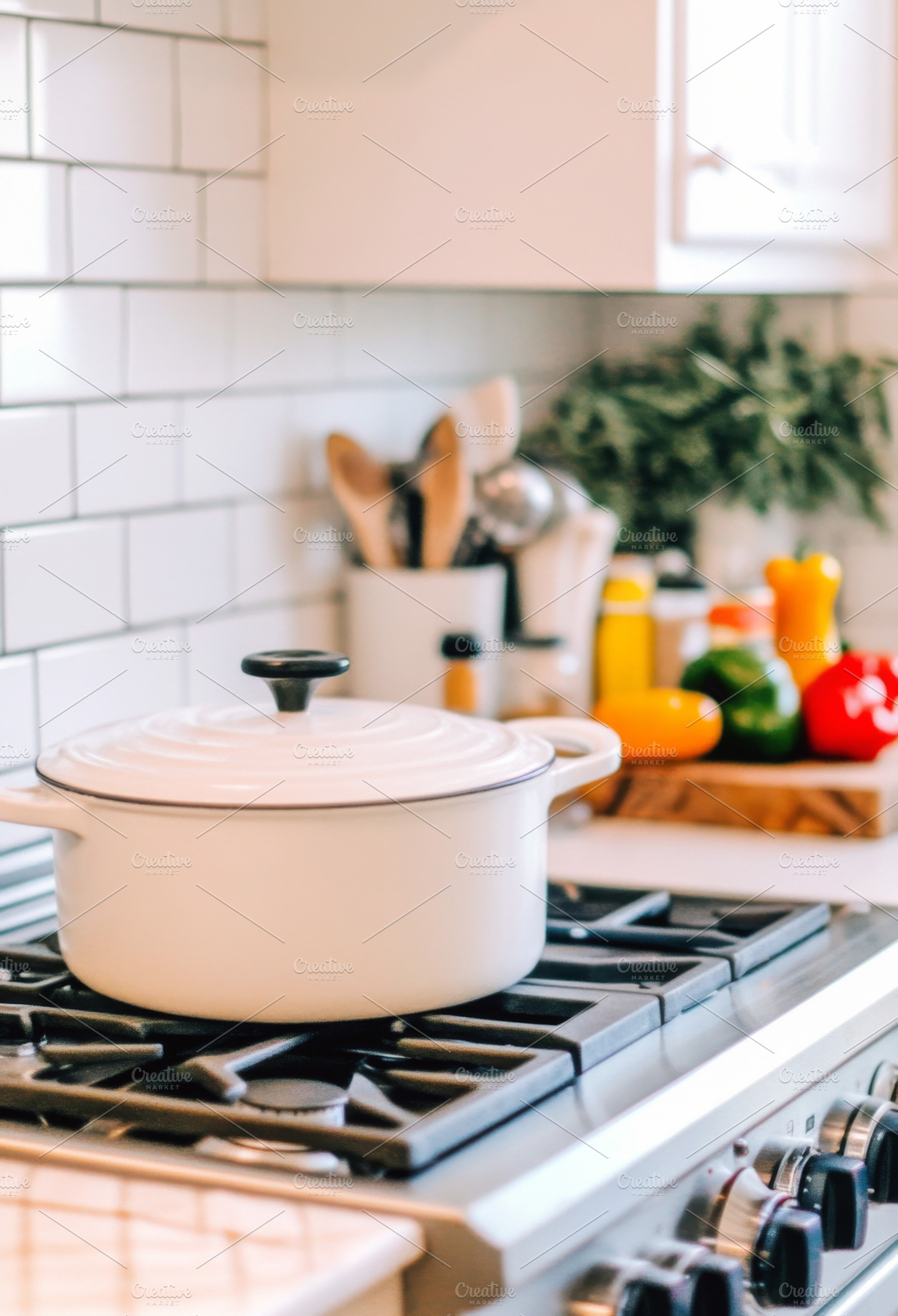 White pot on a stovetop in a modern, a Photo by Dvoevnore photos