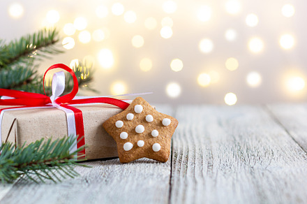 Gingerbread star and box of gift on bokeh lights background, a Holiday Photo by dashtik