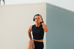 Young slim woman wearing headphones, a Sports & Recreation Photo by Artem Varnitsin