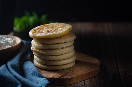 Traditional Venezuelan food arepa made from cornmeal with copy space, a Food & Drink Photo by zakiroff