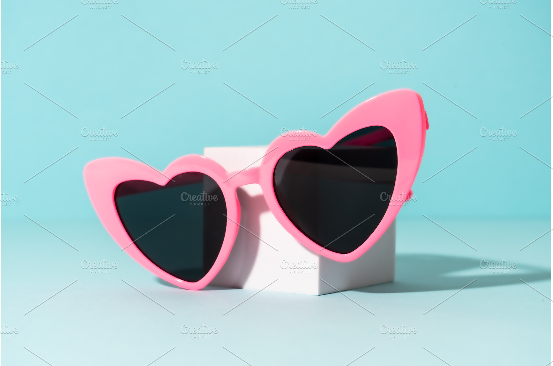Sunglasses on white podium with, an Arts & Entertainment Photo by Nadia-nb