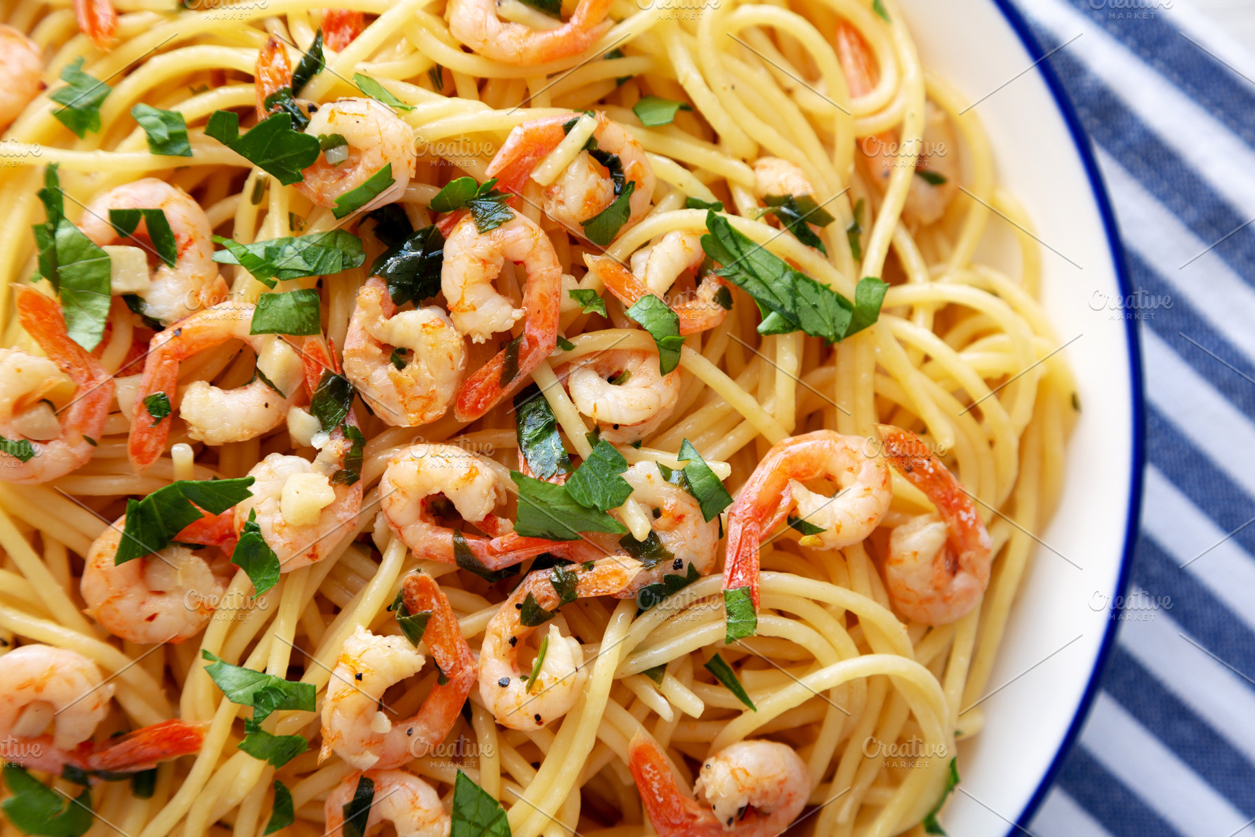 Homemade Garlic Shrimp Scampi with Parsley on a Plate, top view., a Food & Drink Photo by LiudmylaChuhunova