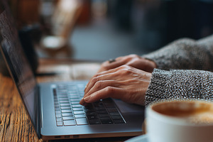 Woman working on laptop in cafe, a Business Photo by MistyDay