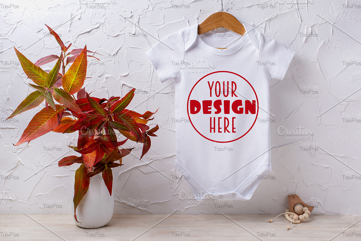 Baby bodysuit mockup with red grass, a Shirt Mockup by TasiPas (Photo 1 of 4)