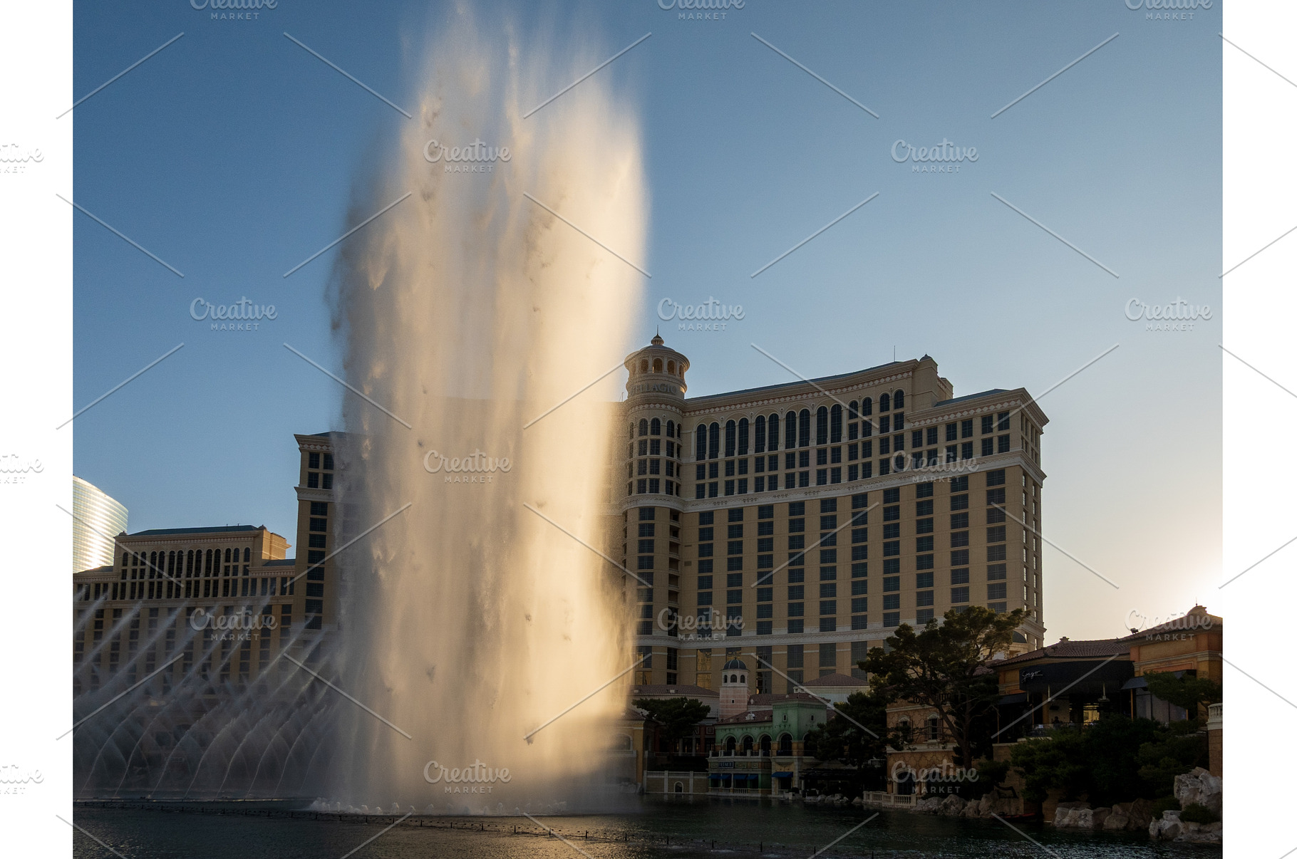 Sunset illuminates the fountains in, an Architecture Photo by Backyard Stock