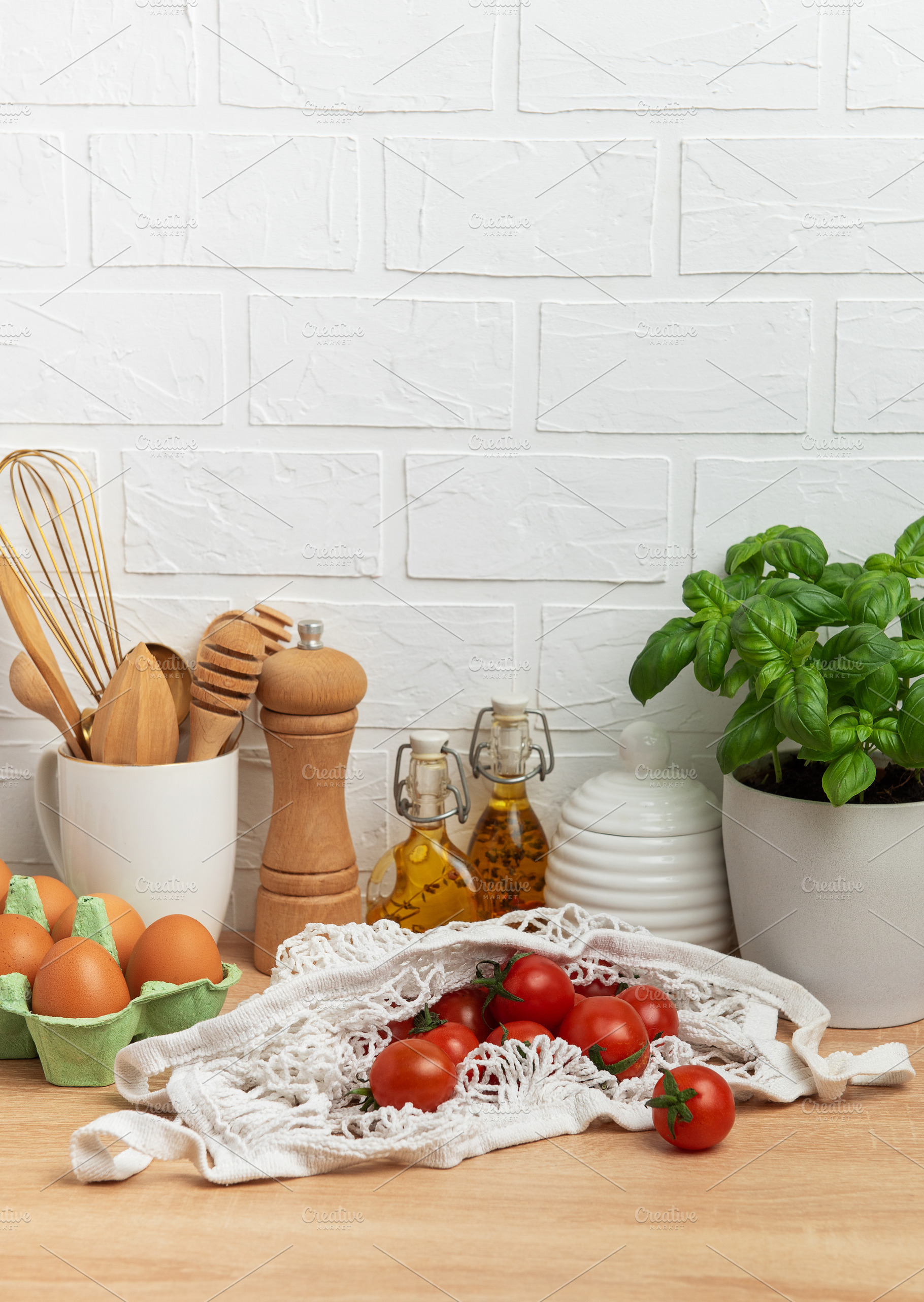 Cherry tomatoes, basil and eggs resting on kitchen counter, embo, a Food & Drink Photo by Olena Rudo