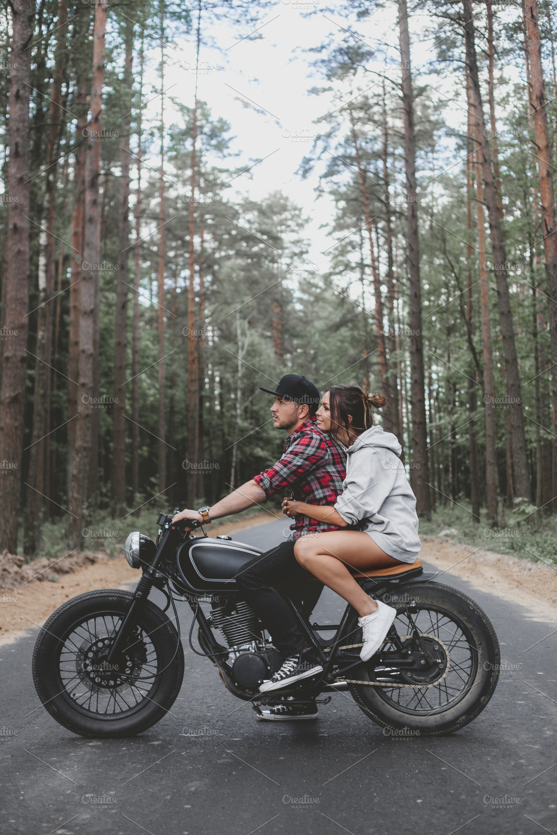 Caucasian couple on motorcycle containing woman, girl, and man, a Transportation Photo by Aliaksei Kaponia