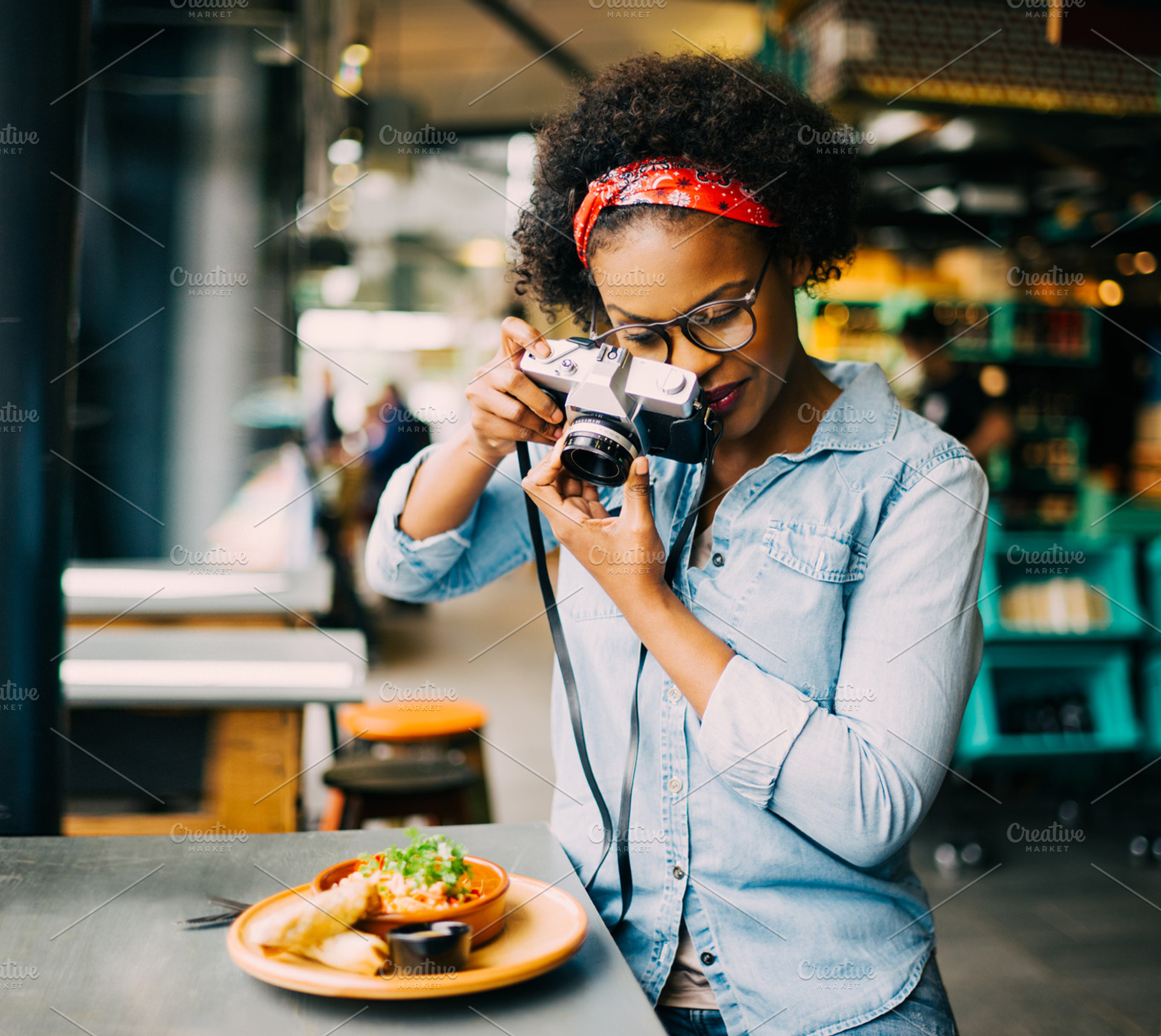 Young woman photographing her food on a cafe counter, a Person Photo by Stefan & Janni