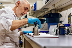 Scientist using a stamp in a laborat, a Health & Medical Photo by Perpis