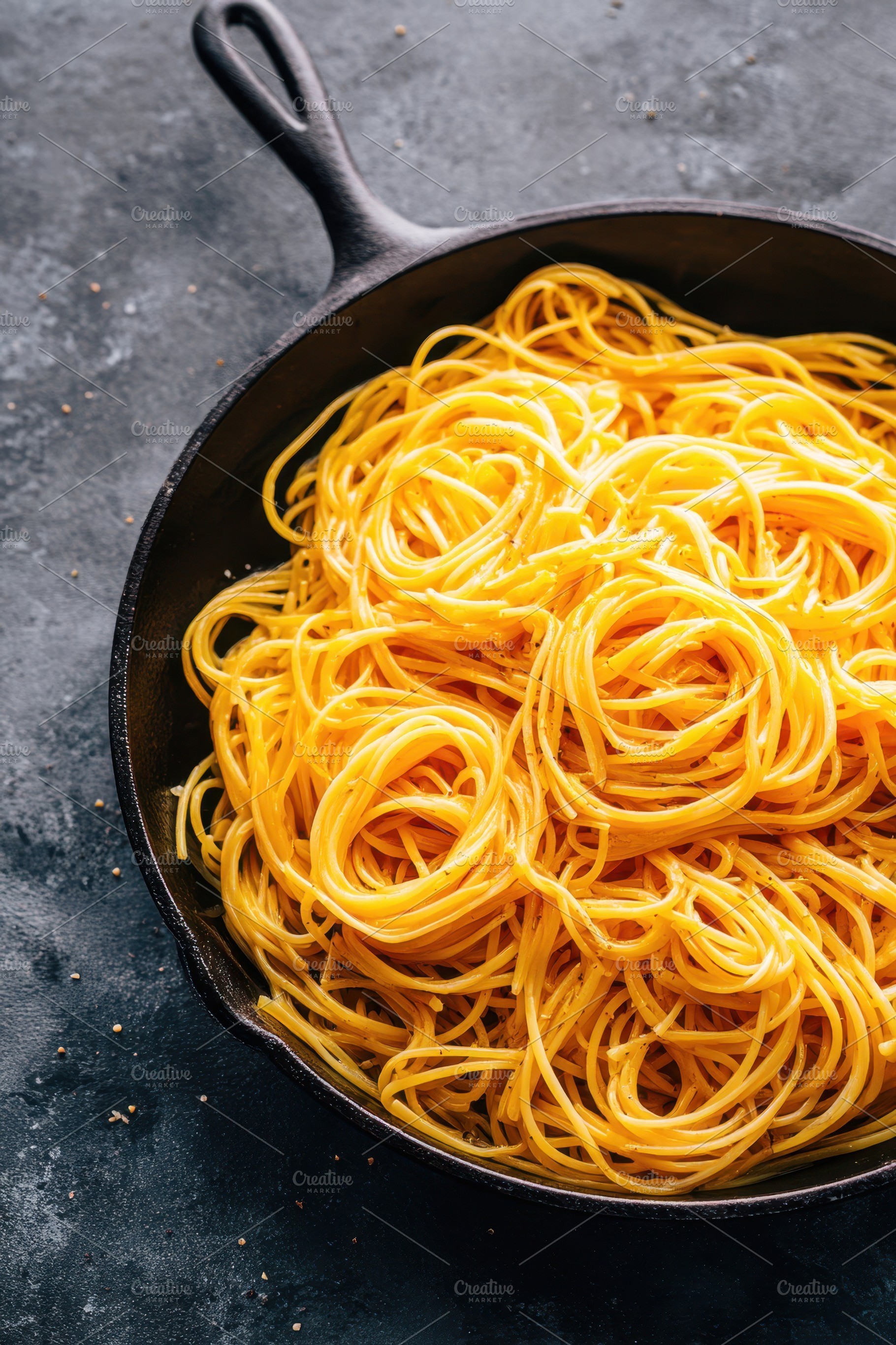 Cooked spaghetti in a cast iron skillet, a Food & Drink Photo by AlyaAnd