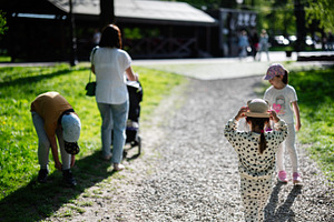 Group of children and adult walking in a park on a sunny day, a Person Photo by AS photostudio