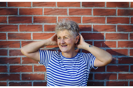 Senior woman standing outdoors, a Nature Photo by HalfPoint