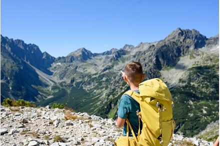 Boy on hike in autumn mountains