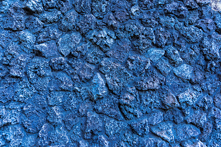 Close-up of a rough blue stone wall with irregular volcanic rock, a Background Photo by Ales Munt