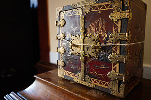 Decorative antique box with ornate details placed on wooden surface indoors, a Photo by AS photostudio