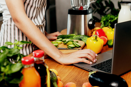 Female hand using laptop at kitchen. Food delivery, mobile dieting app, a Food & Drink Photo by Lenor4ik