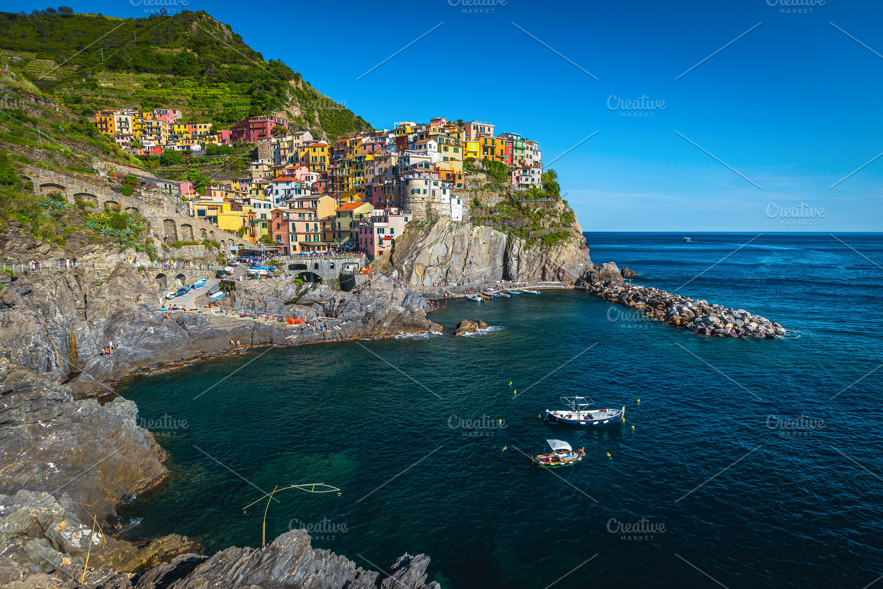 Anchored boats in the bay, Manarola, an Architecture Photo by Alpine Dreams