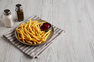 Homemade French Fries and Ketchup on a Plate, side view. Copy sp, a Food & Drink Photo by LiudmylaChuhunova