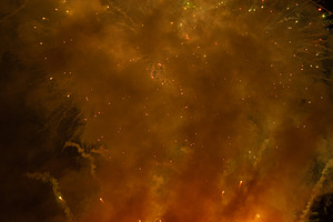 Fireworks exploding behind a wall of smoke